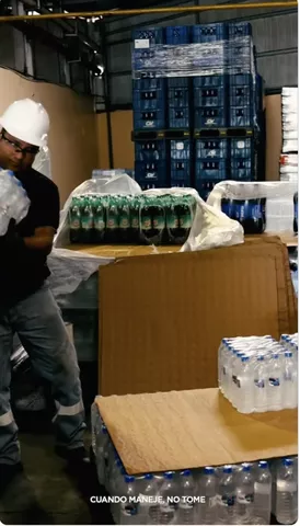 Colaborador de Cervecería Nacional prepara agua embotellada en un centro de distribución